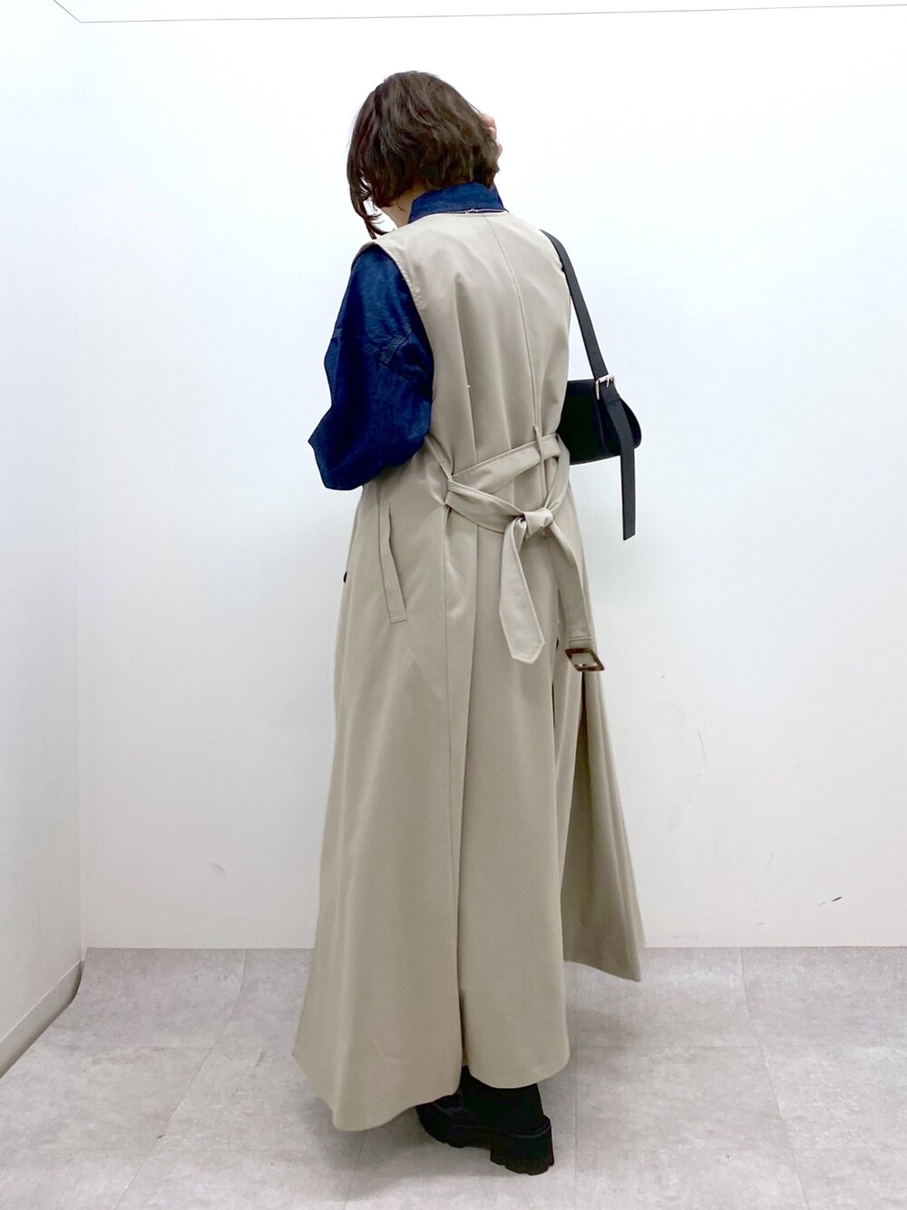 ベージュ系のジャケット/アウター、ブラック系のパンツ、ブルー系のトップスを着用したレディースの春コーディネートの4枚目の写真