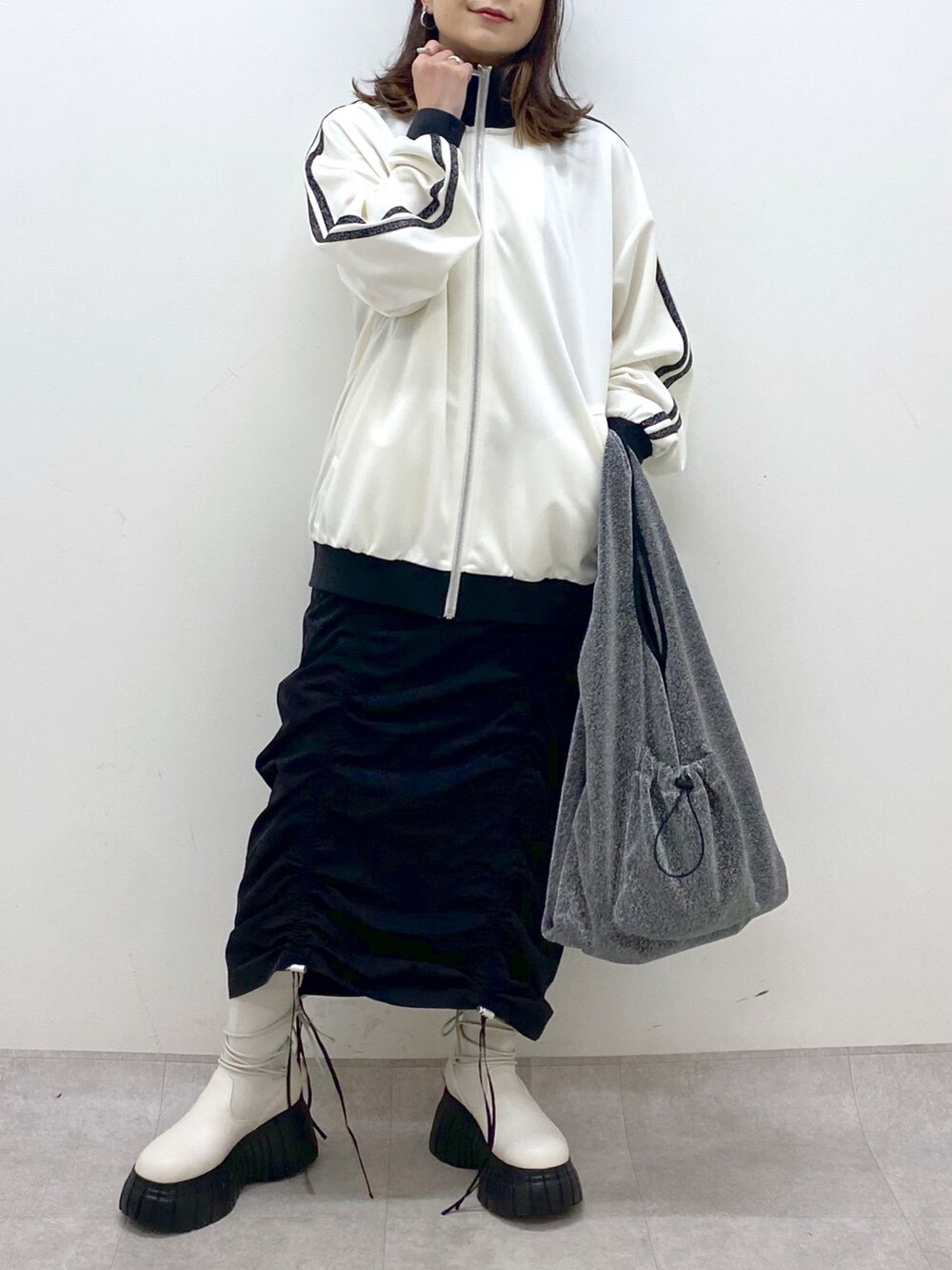 ブラック系のワンピース、ホワイト系のその他アウター、ブラック系のトートバッグを着用したレディースの冬コーディネートの6枚目の写真