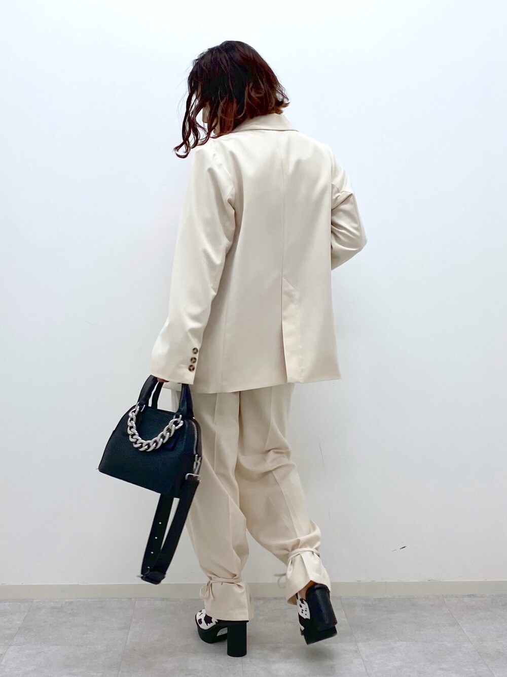 レッド系のタンクトップ、ホワイト系のその他パンツ、ブラック系のショルダーバッグを着用したレディースの春コーディネートの4枚目の写真