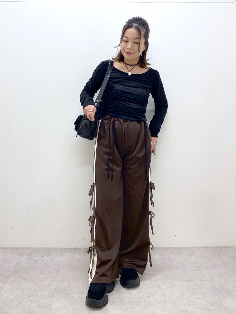 ブラウン系のその他パンツ、ブラック系のTシャツ/カットソー、ブラック系のショルダーバッグを着用したレディースの夏コーディネートの9枚目の写真