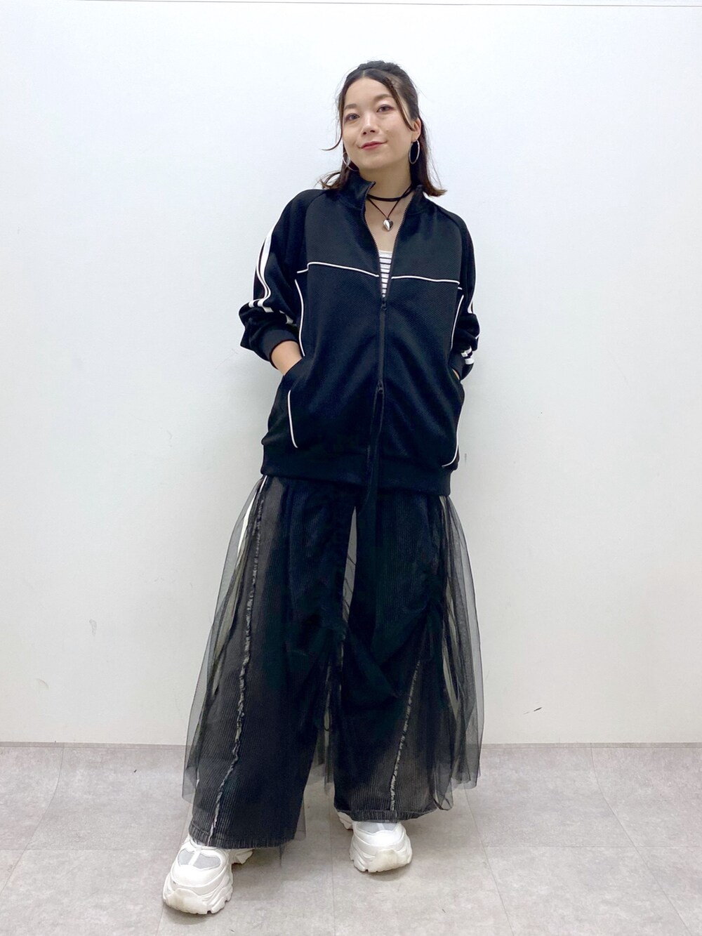 ブラック系のデニムパンツ、ホワイト系のスニーカー、ブラック系のジャージを着用したレディースの夏コーディネートの9枚目の写真