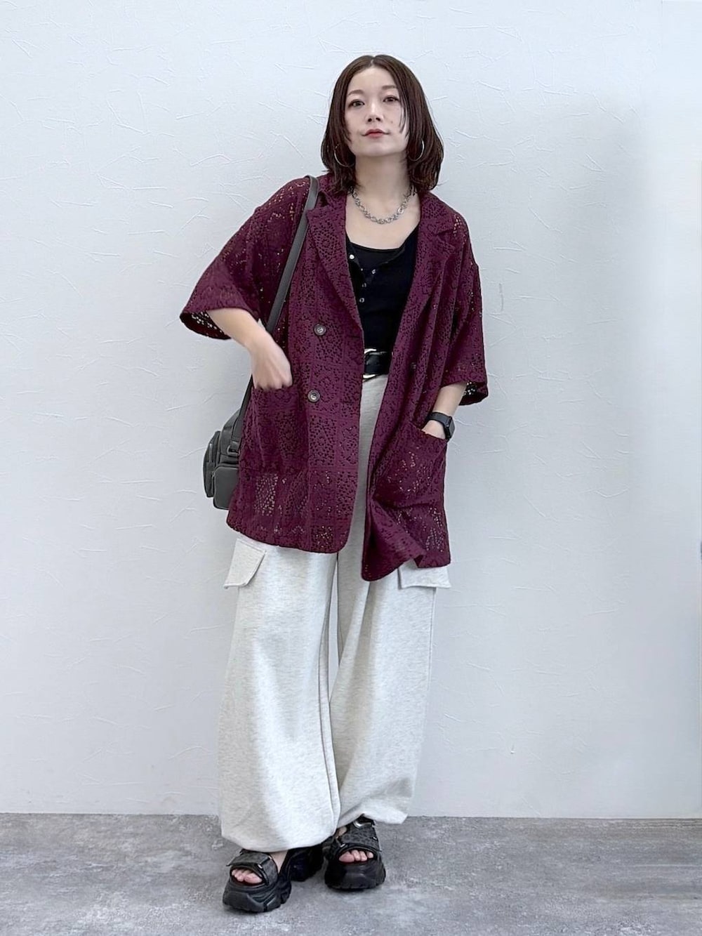 グレー系のショルダーバッグ、ブラック系のタンクトップ、ベージュ系のその他パンツを着用したレディースの春コーディネートの4枚目の写真