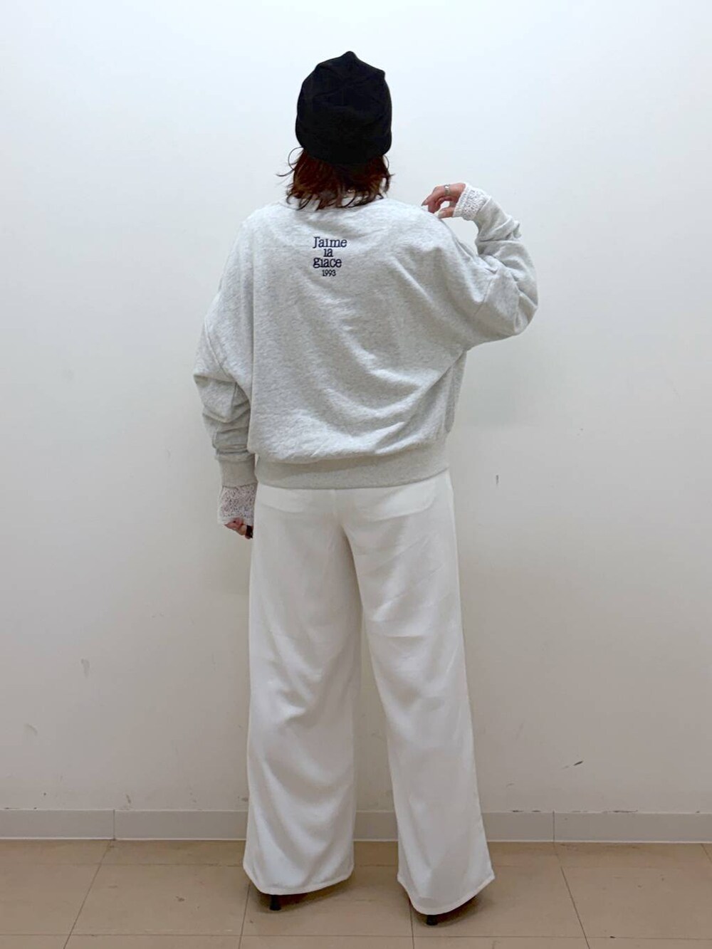 グレー系のスウェット、ホワイト系のスラックス、ホワイト系のTシャツ/カットソーを着用したレディースの冬コーディネートの6枚目の写真