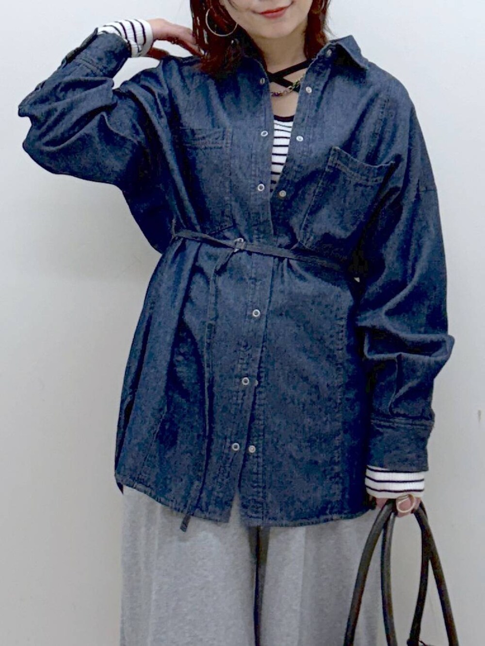 ブラック系のボストンバッグ、グレー系のスウェットパンツ、ブルー系のシャツ/ブラウスを着用したレディースの冬コーディネートの2枚目の写真