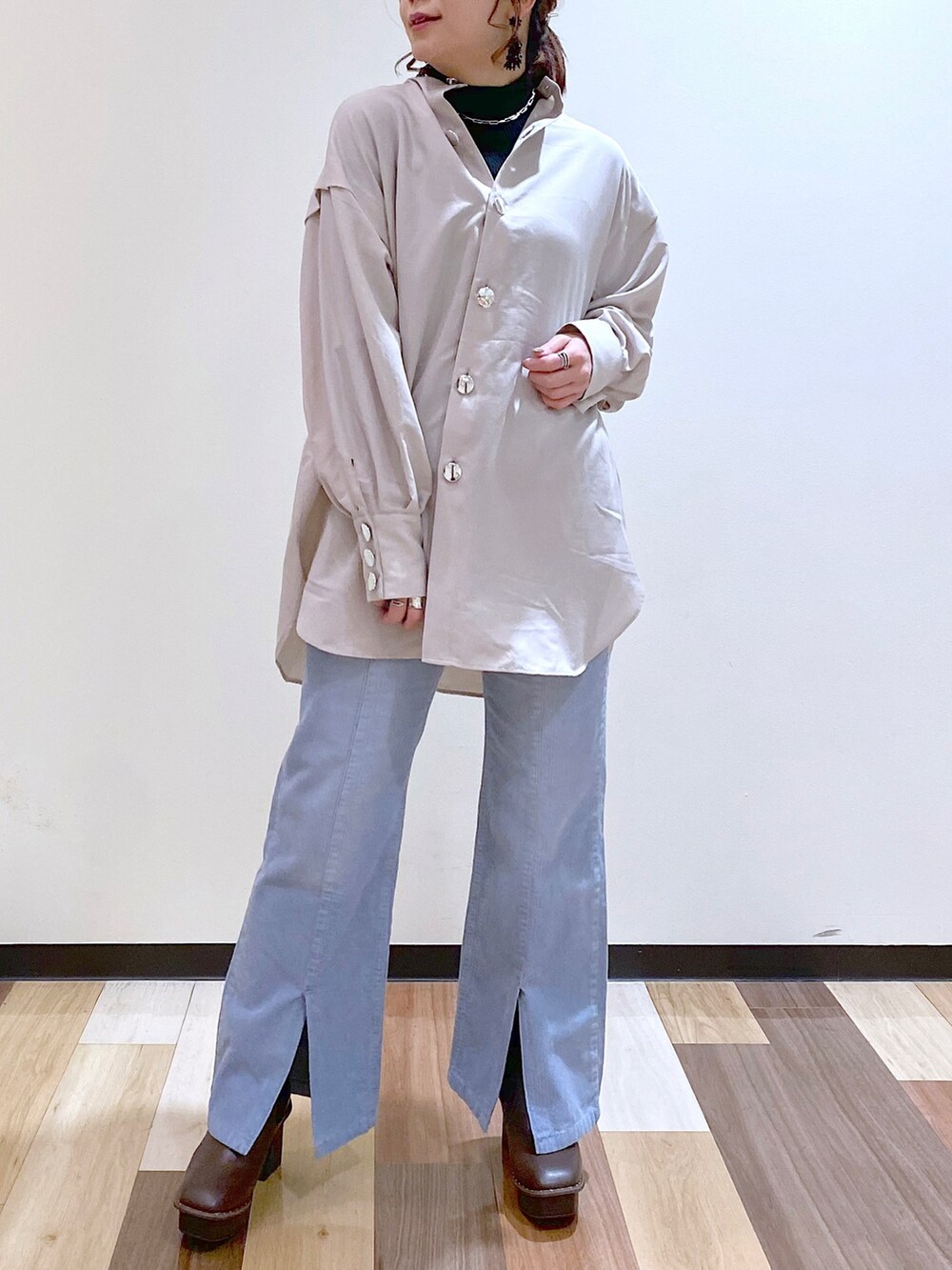 ベージュ系のシャツ/ブラウス、ブラック系のニット/セーター、ブルー系のその他パンツを着用したレディースの冬コーディネートの4枚目の写真