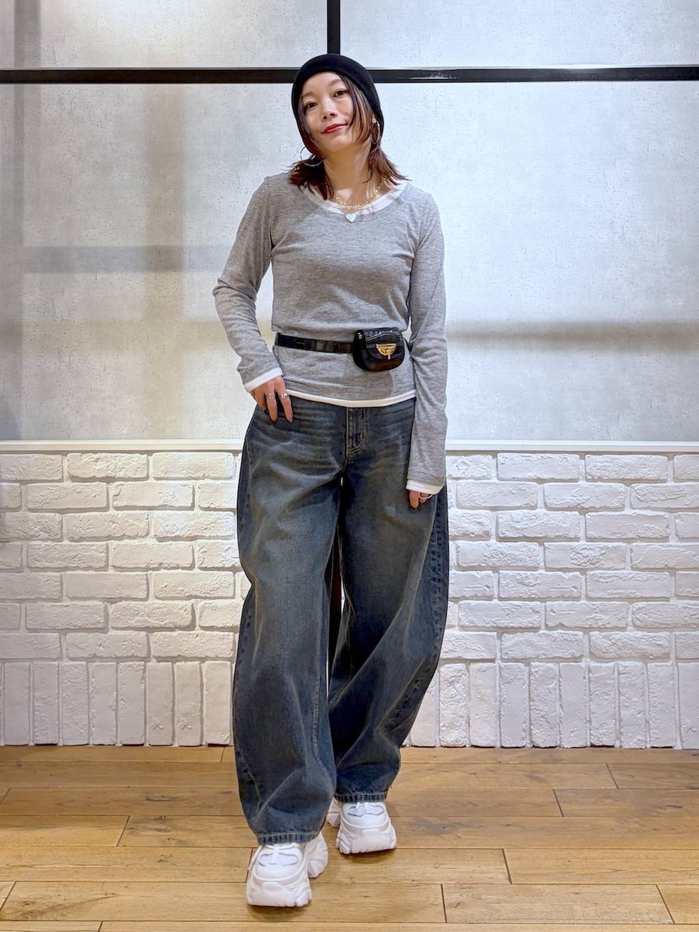 ホワイト系のスニーカー、ブラック系のボディバッグ/ウエストポーチ、ブルー系のデニムパンツを着用したレディースの春コーディネートの9枚目の写真