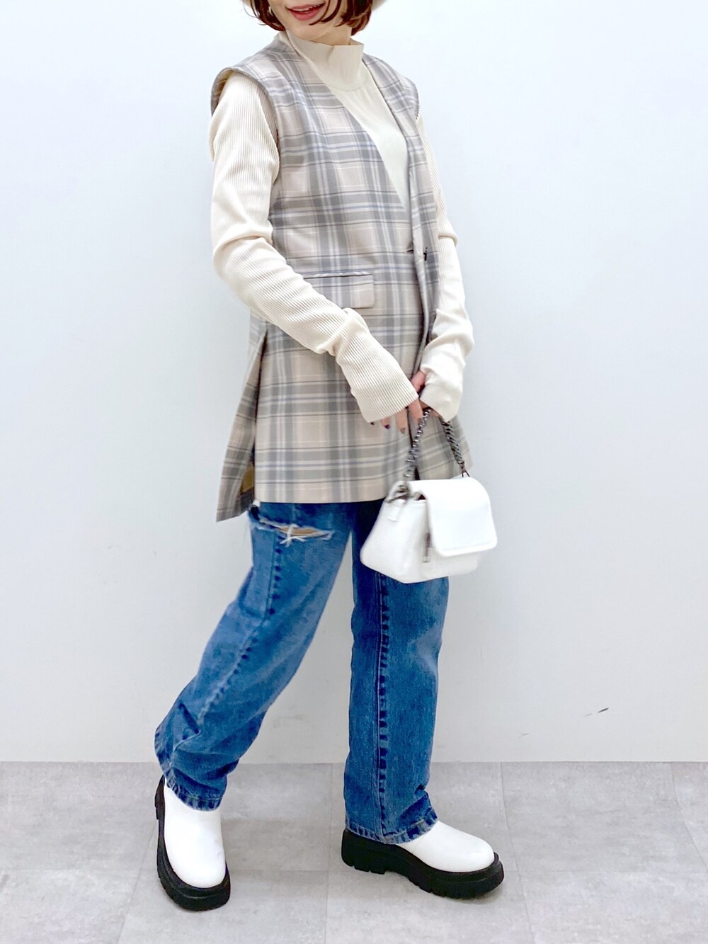 グレー系のジャケット/アウター、ブルー系のデニムパンツ、ホワイト系のバッグを着用したレディースの秋コーディネートの5枚目の写真