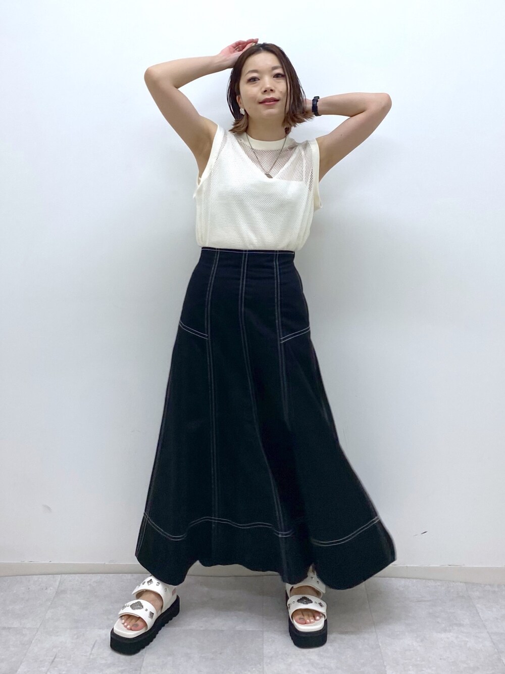 ホワイト系のトップス、イエロー系のシャツ/ブラウス、ブラック系のスカートを着用したレディースの夏コーディネートの5枚目の写真