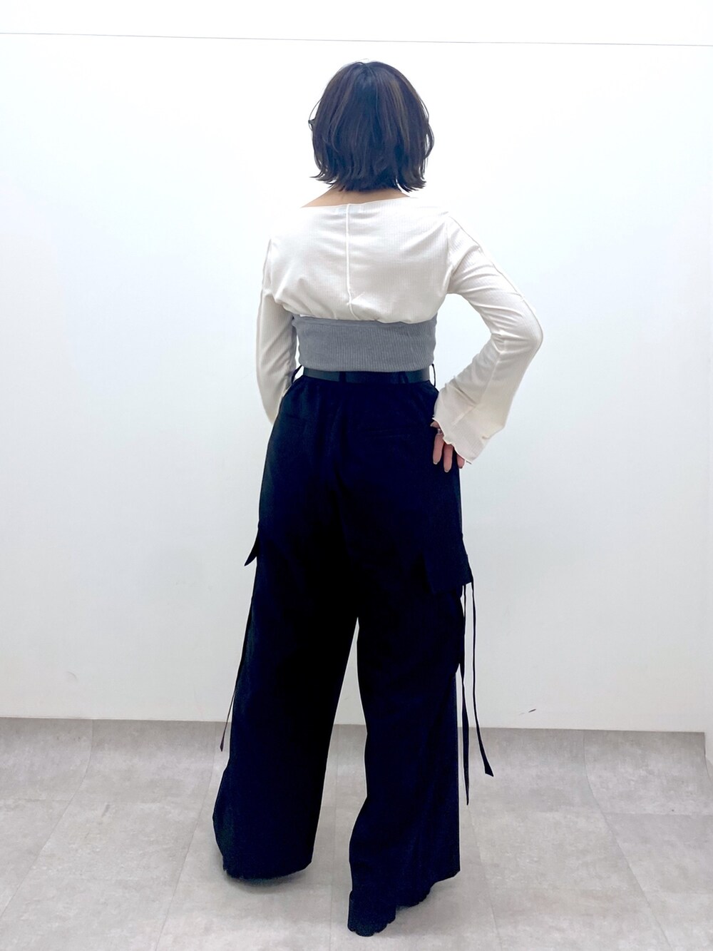 ブラック系のパンツ、グレー系のトップス、ホワイト系のトップスを着用したレディースの春コーディネートの3枚目の写真