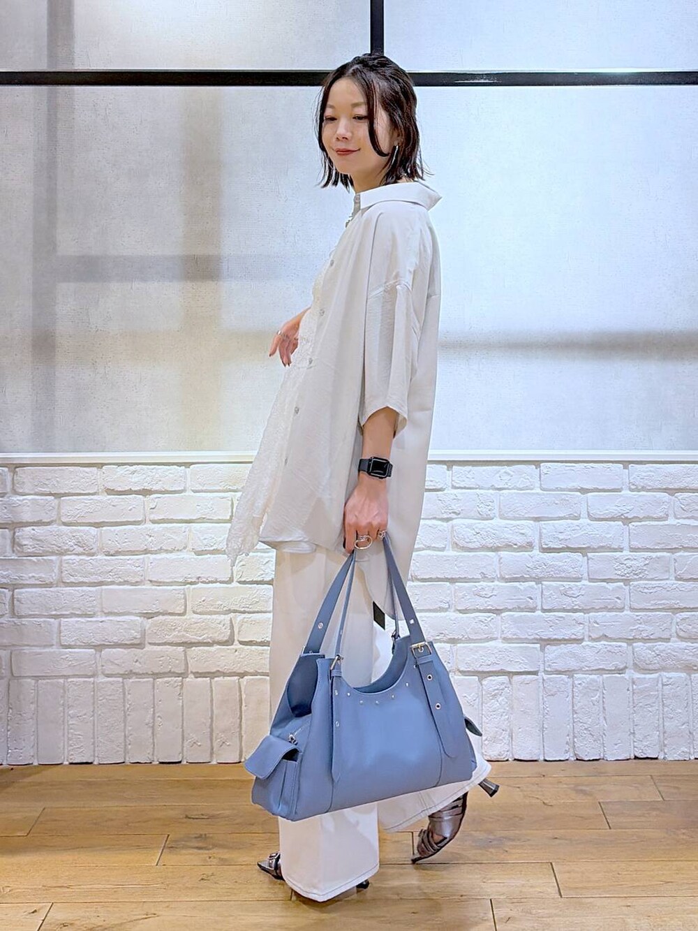 ホワイト系のデニムパンツ、その他のサンダル、ブルー系のハンドバッグを着用したレディースの夏コーディネートの5枚目の写真