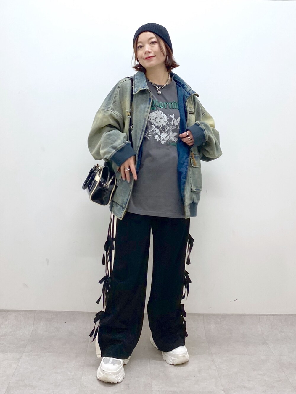 ブラック系のその他パンツ、ホワイト系のスニーカー、ブラック系のショルダーバッグを着用したレディースの秋コーディネートの9枚目の写真