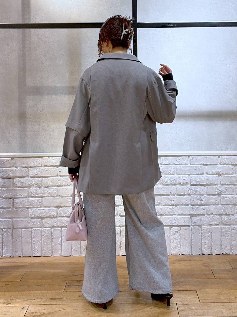 ピンク系のハンドバッグ、グレー系のスウェットパンツ、ブラック系のサンダルを着用したレディースの春コーディネートの6枚目の写真