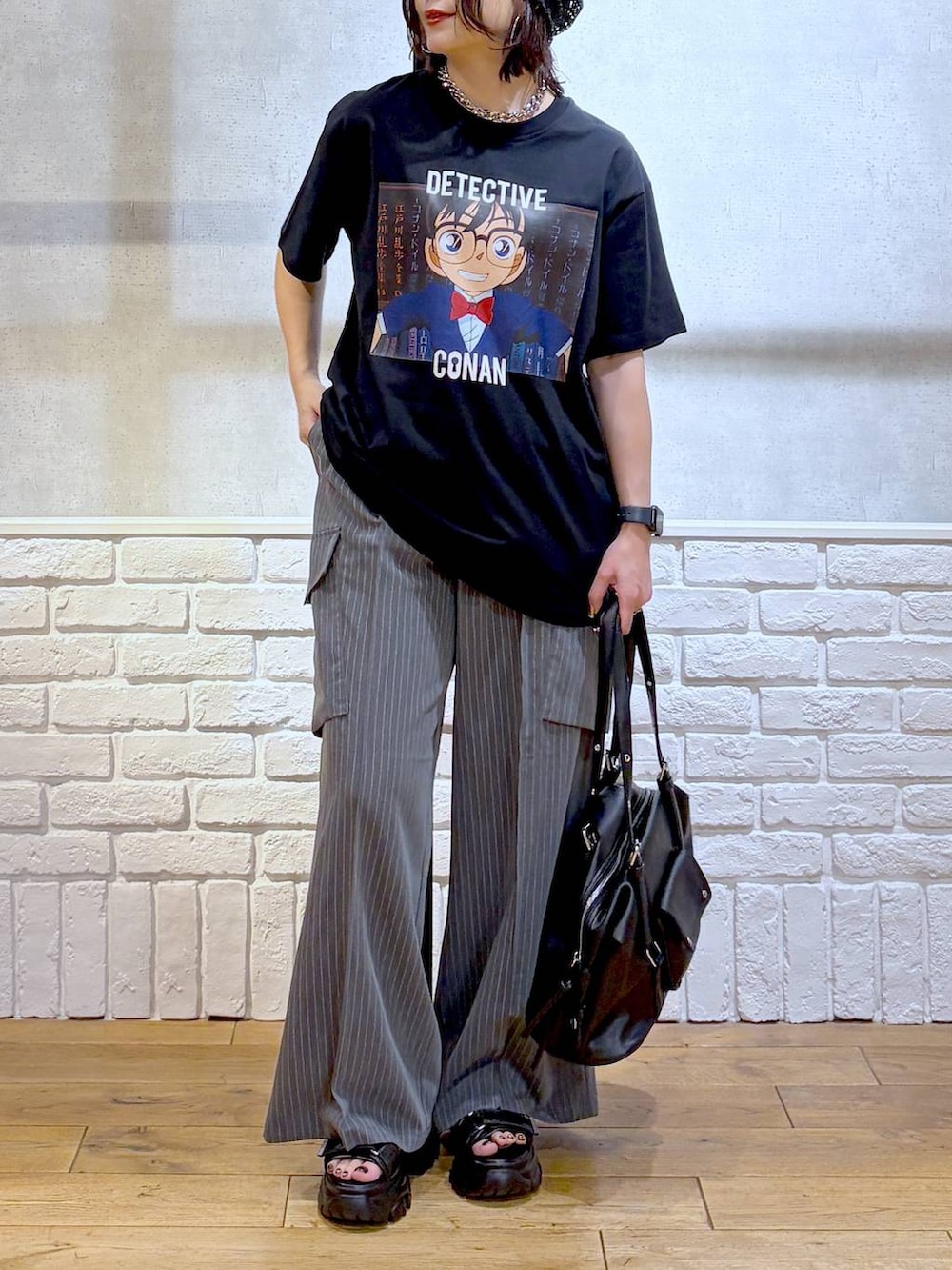 ブラック系のサンダル、ブラック系のボストンバッグ、ブラック系のTシャツ/カットソーを着用したレディースの春コーディネートの3枚目の写真