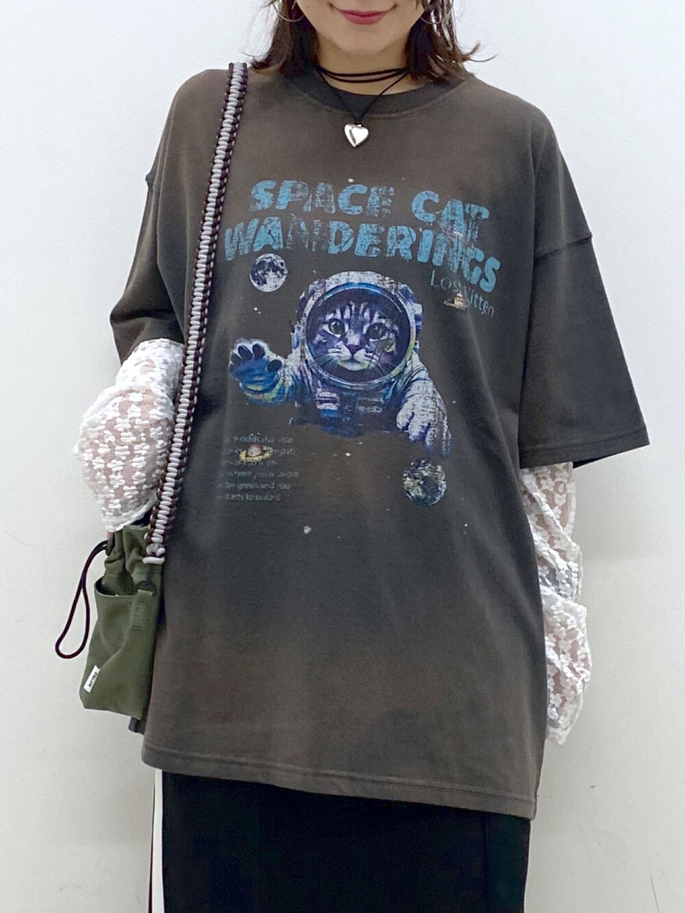 グレー系のTシャツ/カットソー、ブラック系のスカート、ホワイト系のスニーカーを着用したレディースの夏コーディネートの2枚目の写真