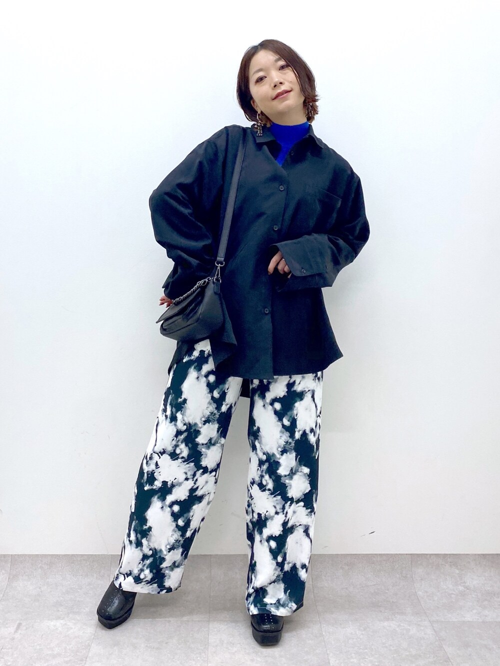 ブラック系のシャツ/ブラウス、ブラック系のバッグ、ブラック系のブーツを着用したレディースの秋コーディネートの2枚目の写真