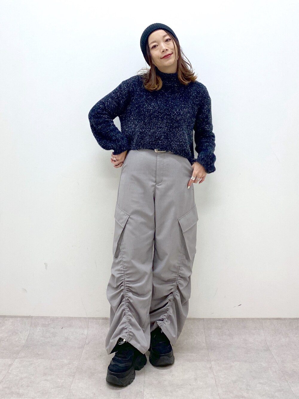 ブラック系のニット/セーター、ベージュ系のその他パンツ、ブラック系のスニーカーを着用したレディースの冬コーディネートの9枚目の写真
