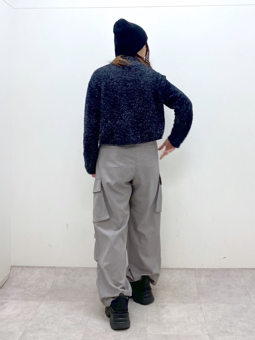 ブラック系のニット/セーター、ベージュ系のその他パンツ、ブラック系のスニーカーを着用したレディースの冬コーディネートの4枚目の写真