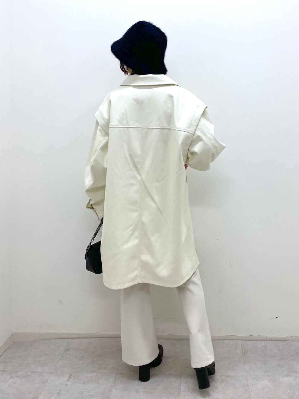 ホワイト系のジャケット/アウター、ブラック系のトップス、ホワイト系のパンツを着用したレディースの秋コーディネートの3枚目の写真