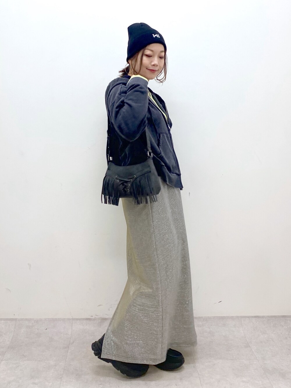 イエロー系のTシャツ/カットソー、ブラック系のパーカー、グレー系のスカートを着用したレディースの春コーディネートの7枚目の写真
