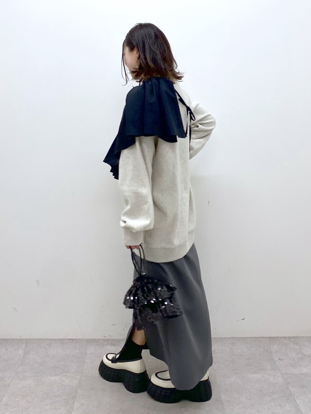 ベージュ系のスウェット、ブラック系のシャツ/ブラウス、ブラック系のショルダーバッグを着用したレディースの冬コーディネートの6枚目の写真