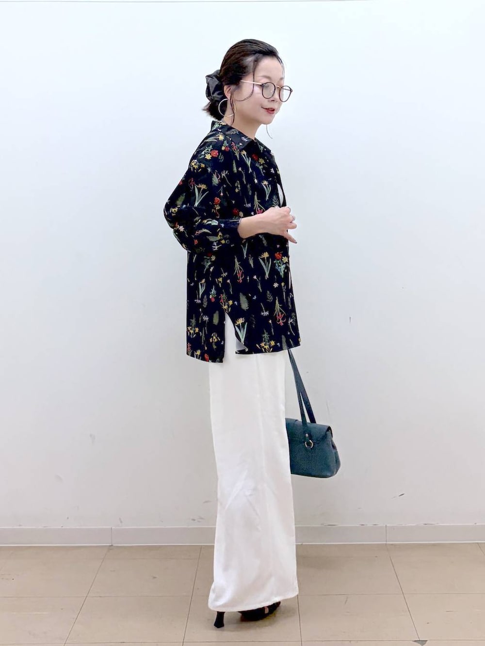 ホワイト系のスラックス、ブラック系のサンダル、グレー系のTシャツ/カットソーを着用したレディースの夏コーディネートの5枚目の写真