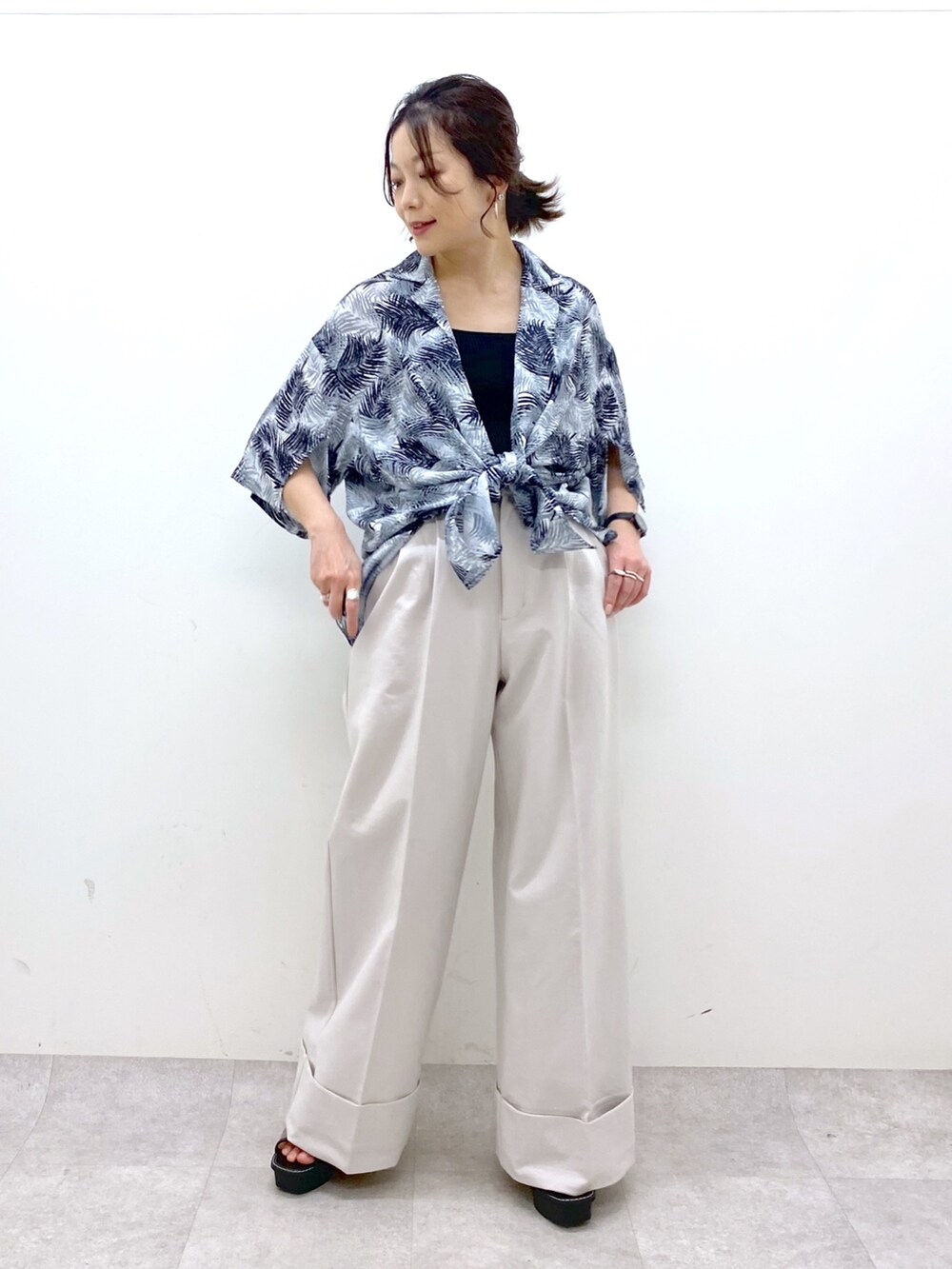 ベージュ系のスラックス、ブラック系のトップス、ブラック系のトップスを着用したレディースの夏コーディネートの8枚目の写真