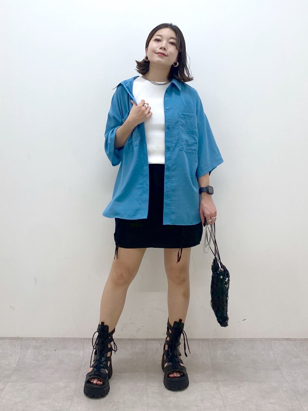 ブルー系のシャツ/ブラウス、ホワイト系のタンクトップ、ブラック系のスカートを着用したレディースの夏コーディネートの9枚目の写真