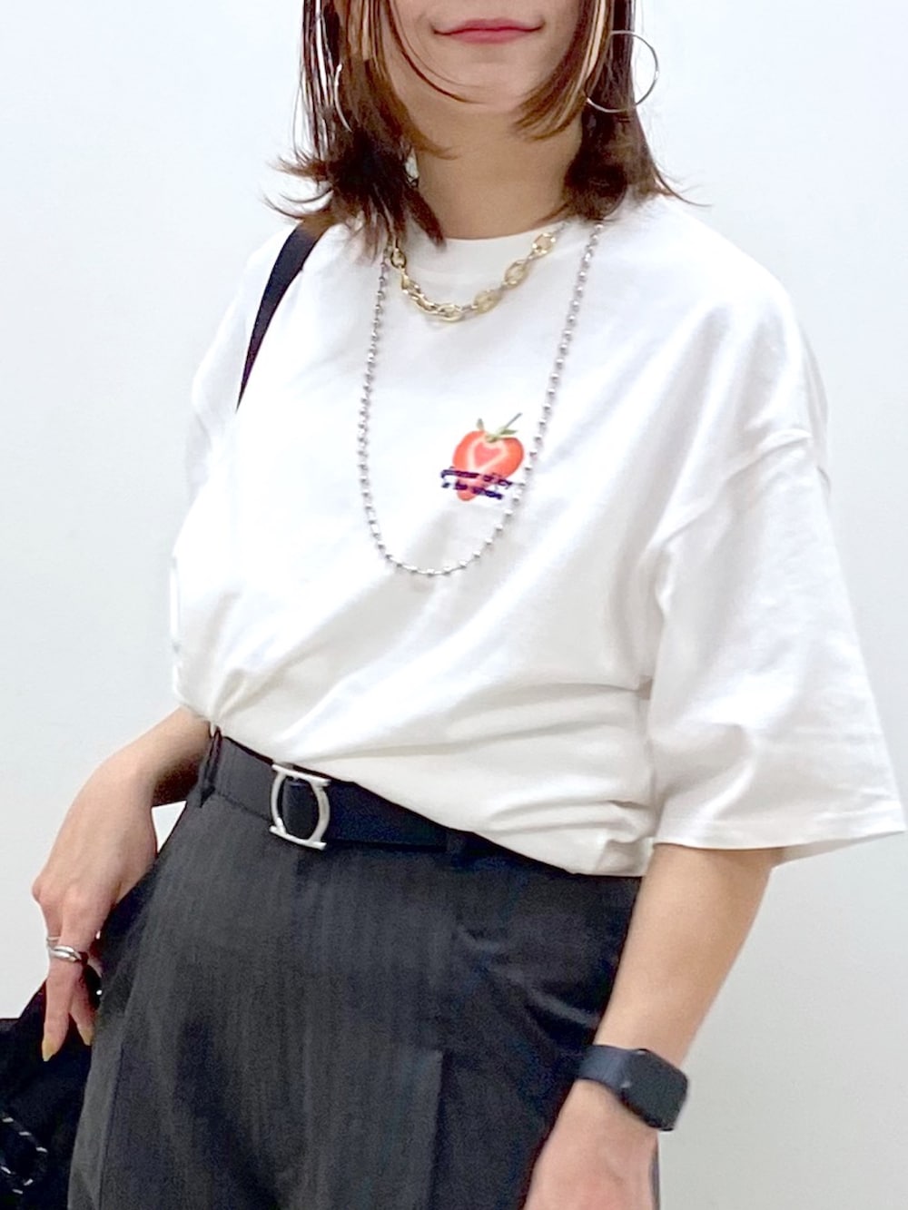 ホワイト系のTシャツ/カットソー、ブラック系のボディバッグ/ウエストポーチ、グレー系のカーゴパンツを着用したレディースの春コーディネートの2枚目の写真