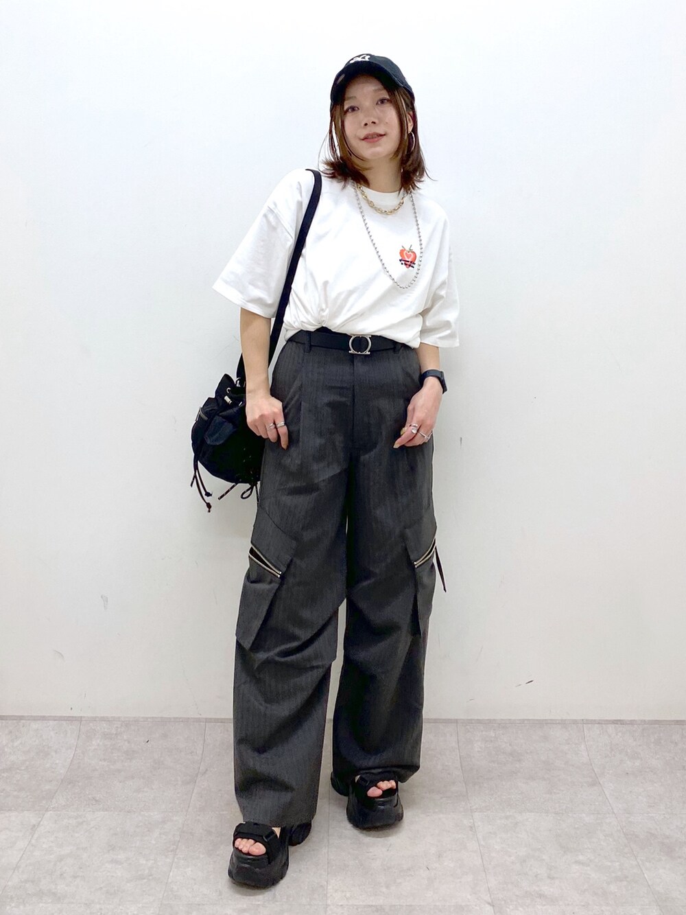 ホワイト系のTシャツ/カットソー、ブラック系のボディバッグ/ウエストポーチ、グレー系のカーゴパンツを着用したレディースの春コーディネートの4枚目の写真