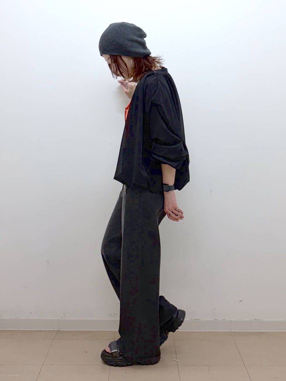 ホワイト系のキャミソール、ブラック系のデニムパンツ、ブラック系のブルゾンを着用したレディースの春コーディネートの8枚目の写真