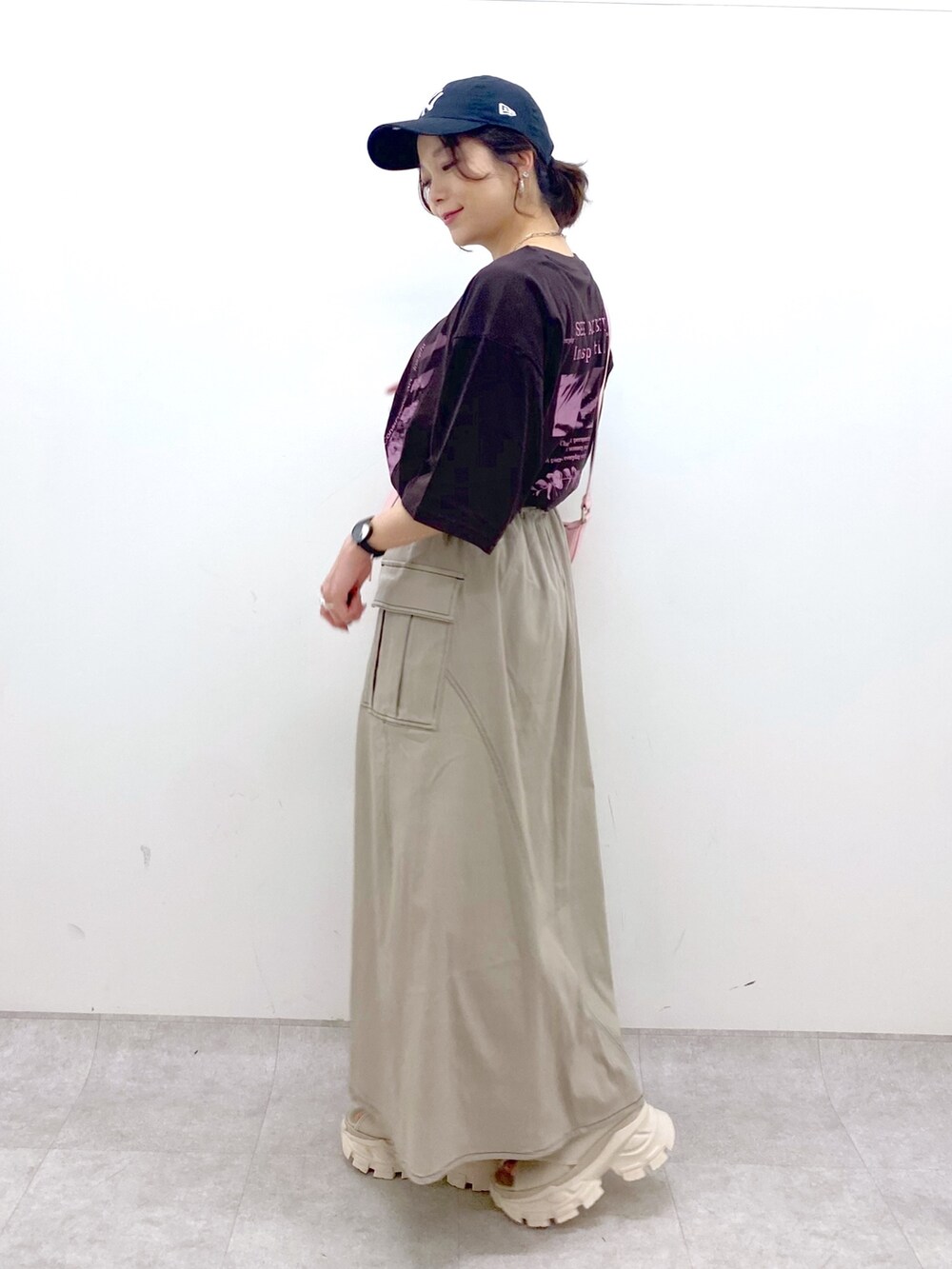 ブラウン系のスカート、ブラウン系のTシャツ/カットソー、ピンク系のショルダーバッグを着用したレディースの夏コーディネートの2枚目の写真