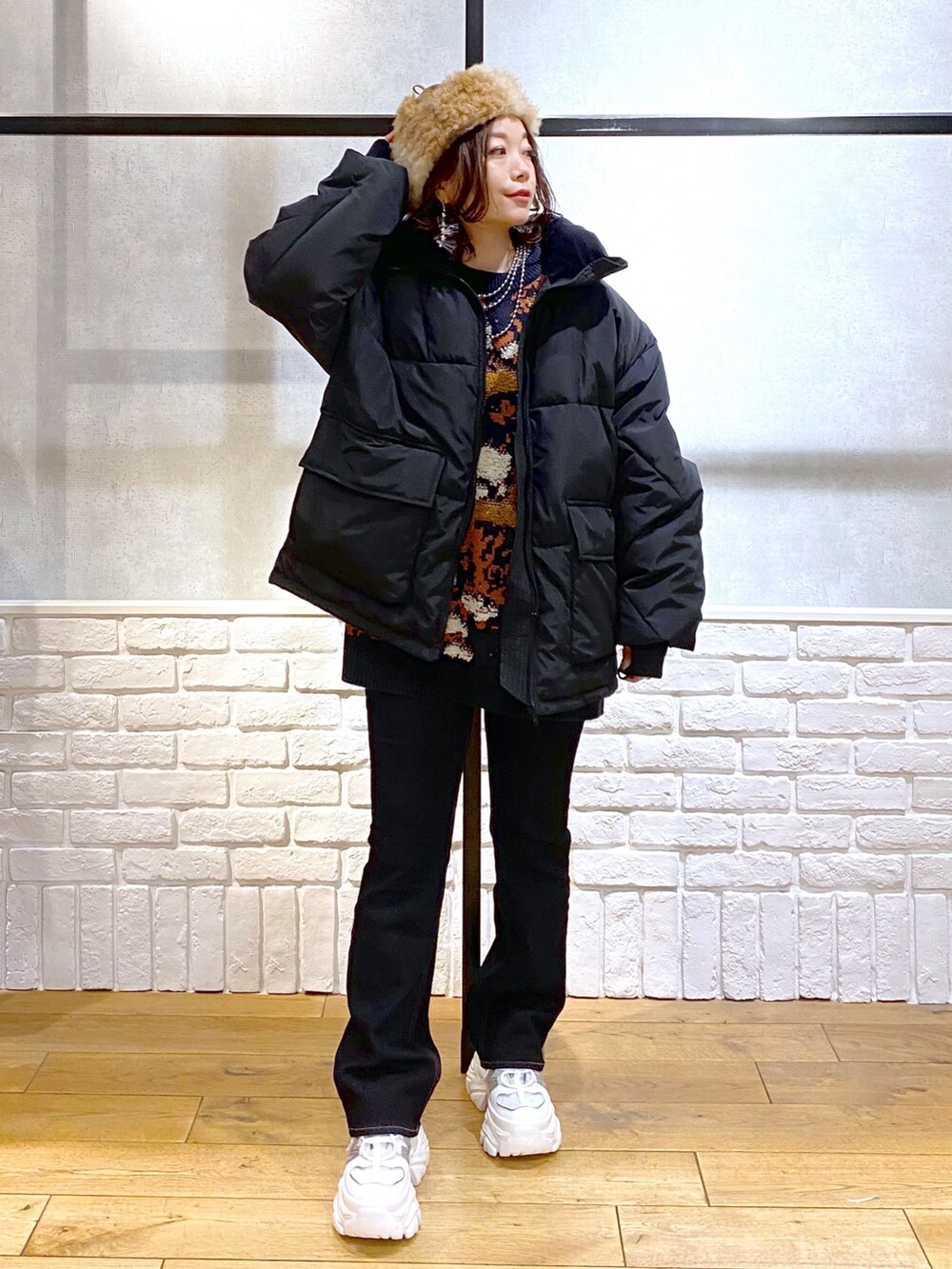 ブルー系のニット/セーター、ブラック系のブルゾン、ブルー系のデニムパンツを着用したレディースの冬コーディネートの8枚目の写真