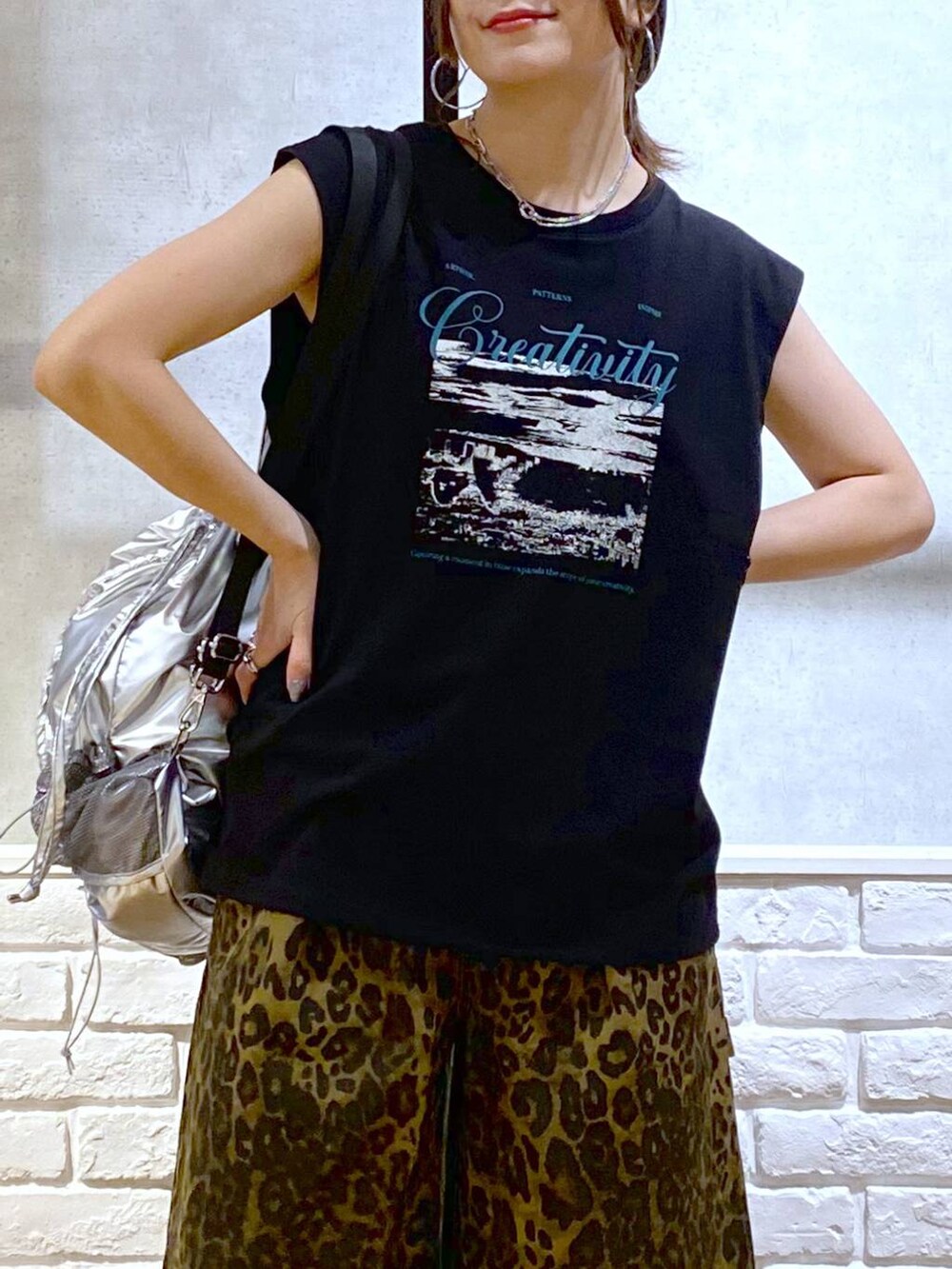 ブラック系のサンダル、シルバー系のバックパック/リュック、その他のその他パンツを着用したレディースの夏コーディネートの2枚目の写真