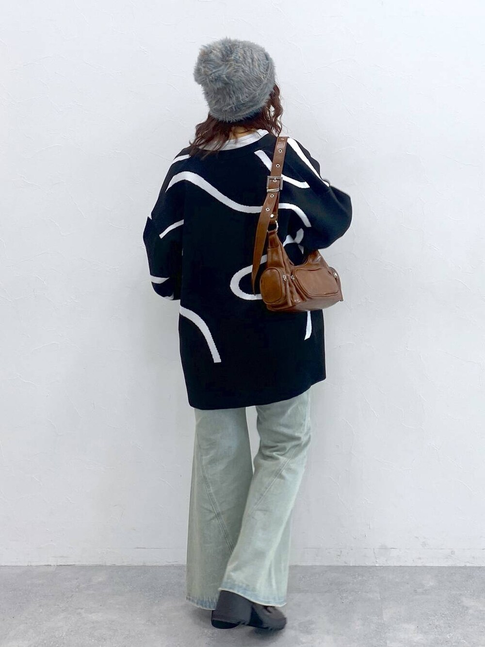 ホワイト系のTシャツ/カットソー、ブルー系のデニムパンツ、ブラック系のカーディガン/ボレロを着用したレディースの秋コーディネートの6枚目の写真