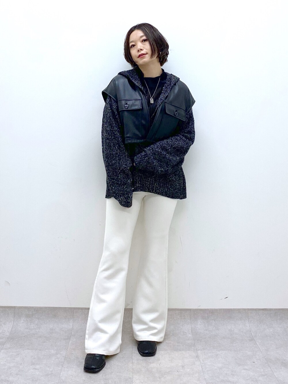 グリーン系のモッズコート、ホワイト系のスラックス、ブラック系のシューズを着用したレディースの冬コーディネートの5枚目の写真