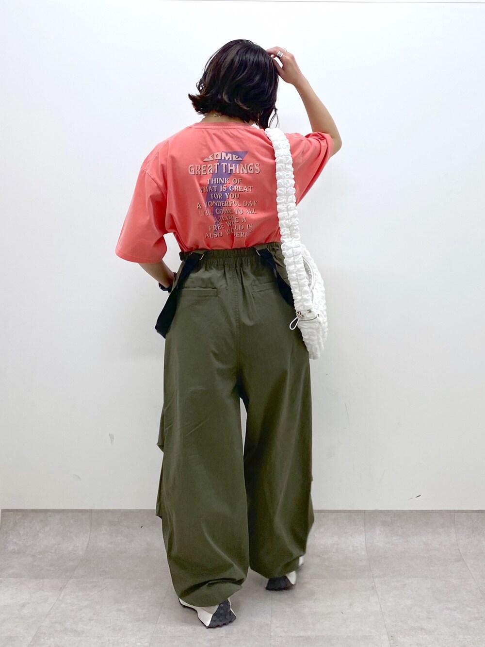 グリーン系のその他パンツ、ホワイト系のバッグ、レッド系のTシャツ/カットソーを着用したレディースの春コーディネートの3枚目の写真