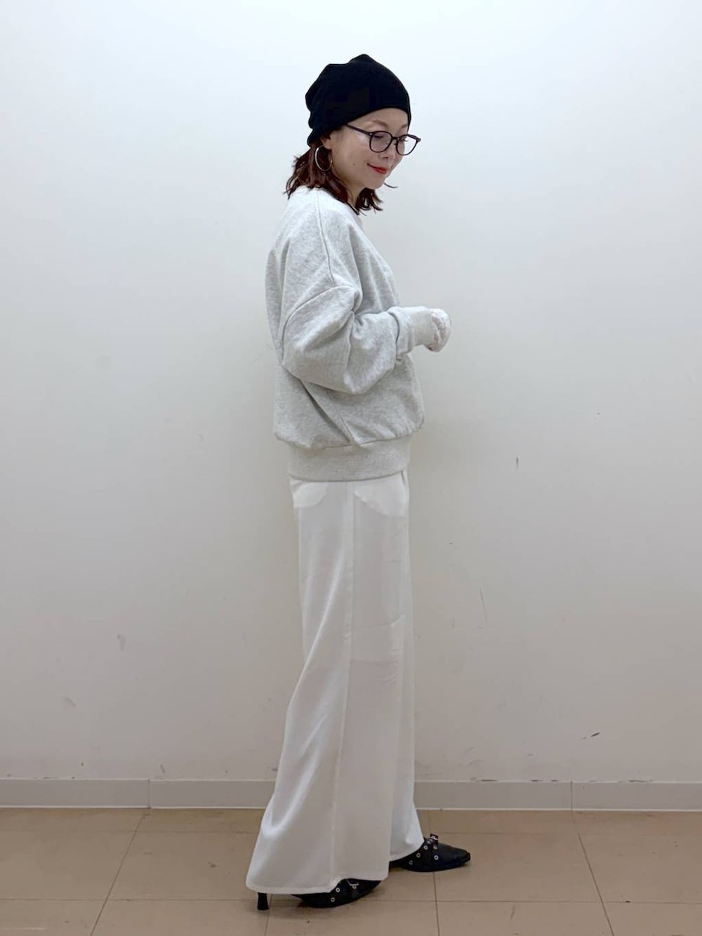 グレー系のスウェット、ホワイト系のスラックス、ホワイト系のTシャツ/カットソーを着用したレディースの冬コーディネートの7枚目の写真