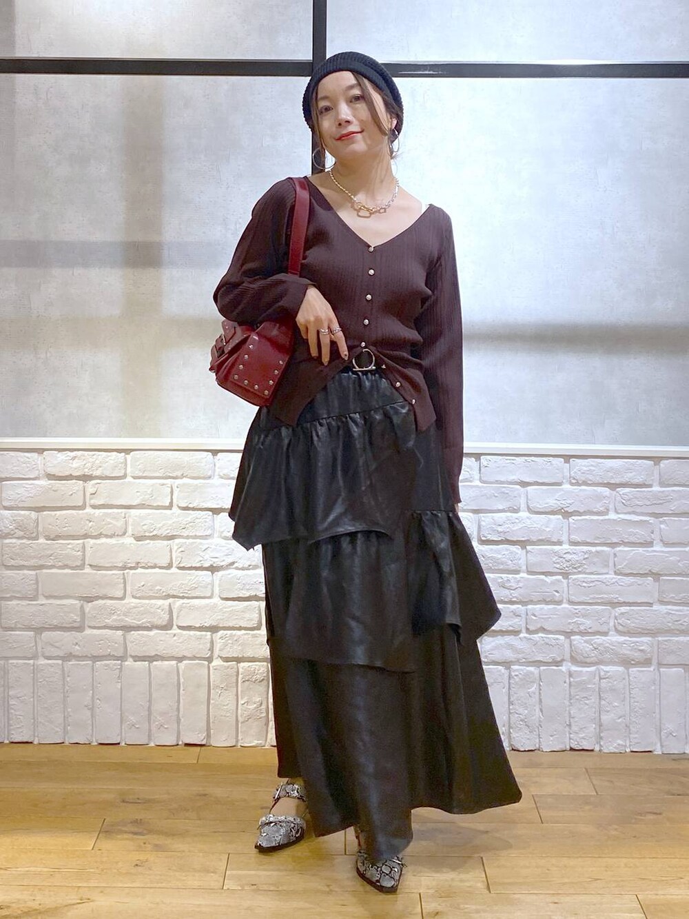 ホワイト系のパンプス、レッド系のショルダーバッグ、ブラック系のスカートを着用したレディースの夏コーディネートの9枚目の写真