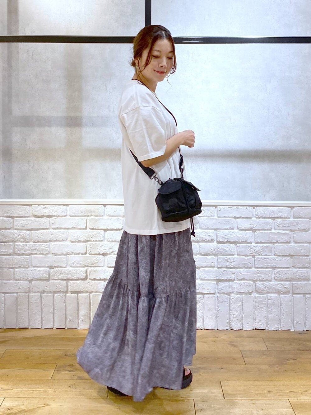 ブラック系のサンダル、ブラック系のショルダーバッグ、グレー系のスカートを着用したレディースの夏コーディネートの7枚目の写真