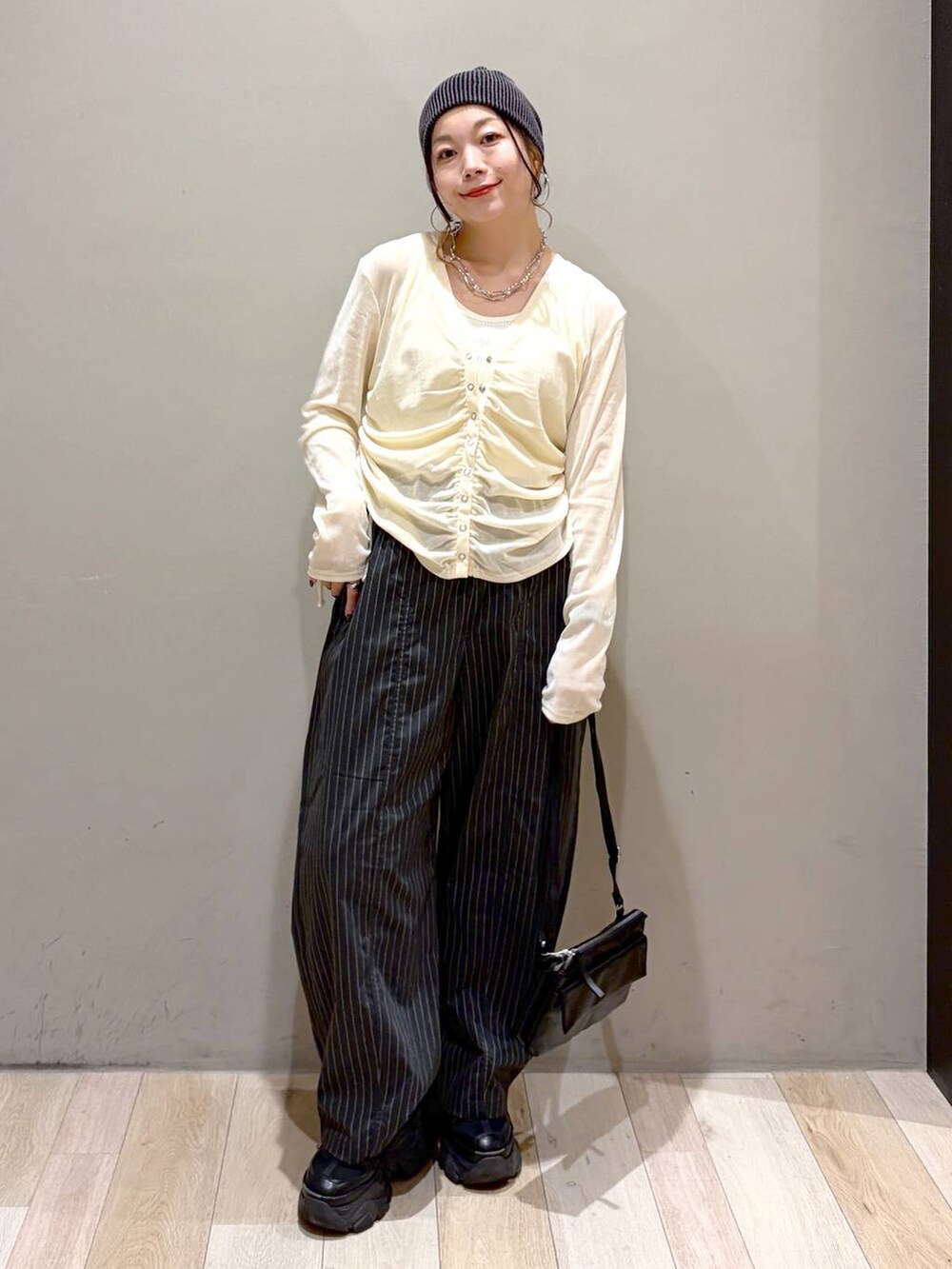 ブラック系のスニーカー、ブラック系のその他パンツ、ホワイト系のタンクトップを着用したレディースの夏コーディネートの4枚目の写真