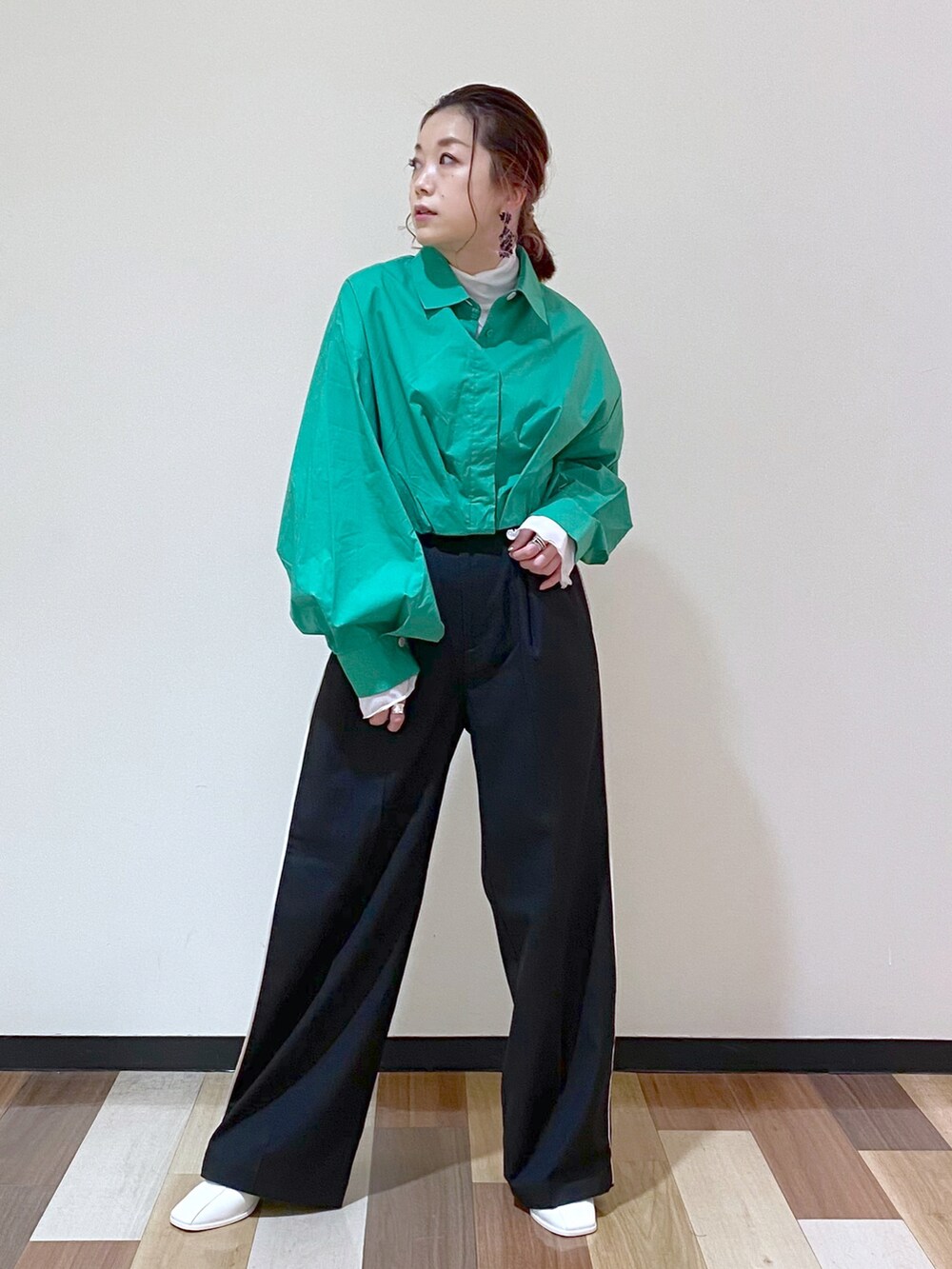 ブラック系のスラックス、ホワイト系のサンダル、ホワイト系のTシャツ/カットソーを着用したレディースの冬コーディネートの5枚目の写真