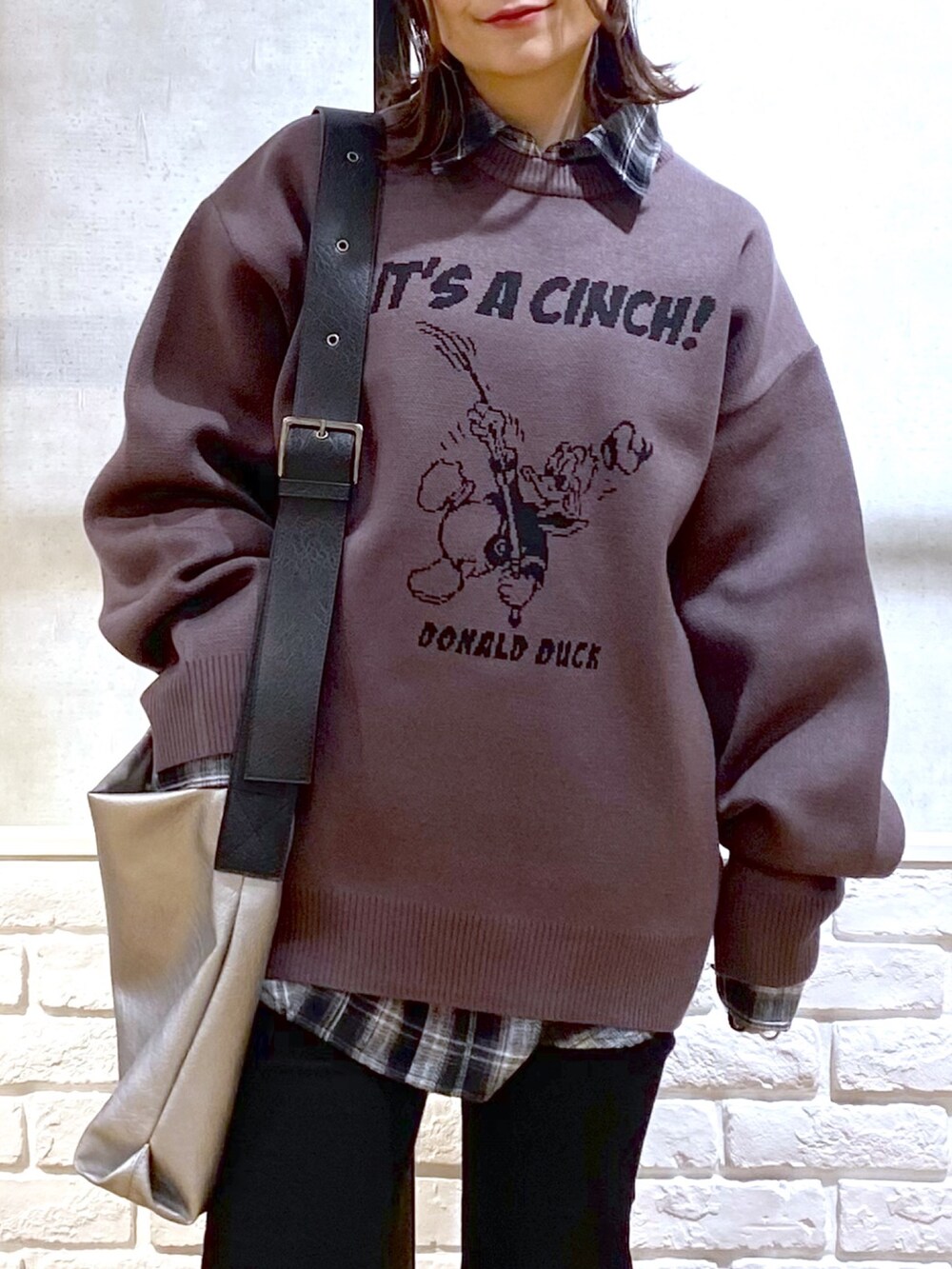 ブラック系のシャツ/ブラウス、シルバー系のトートバッグ、ブラック系のデニムパンツを着用したレディースの冬コーディネートの2枚目の写真