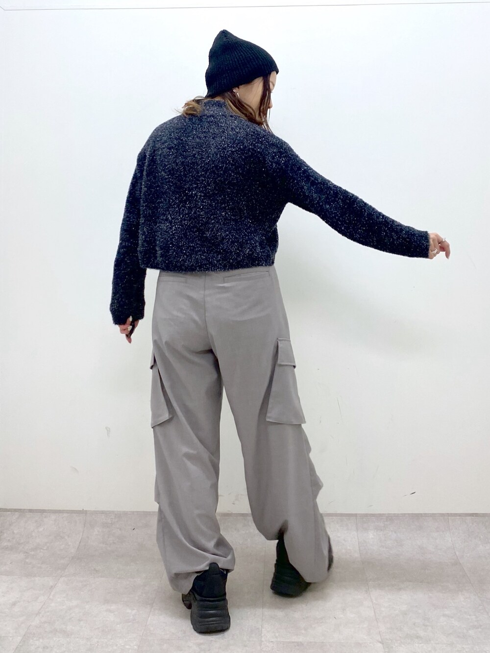 ブラック系のニット/セーター、ベージュ系のその他パンツ、ブラック系のスニーカーを着用したレディースの冬コーディネートの5枚目の写真