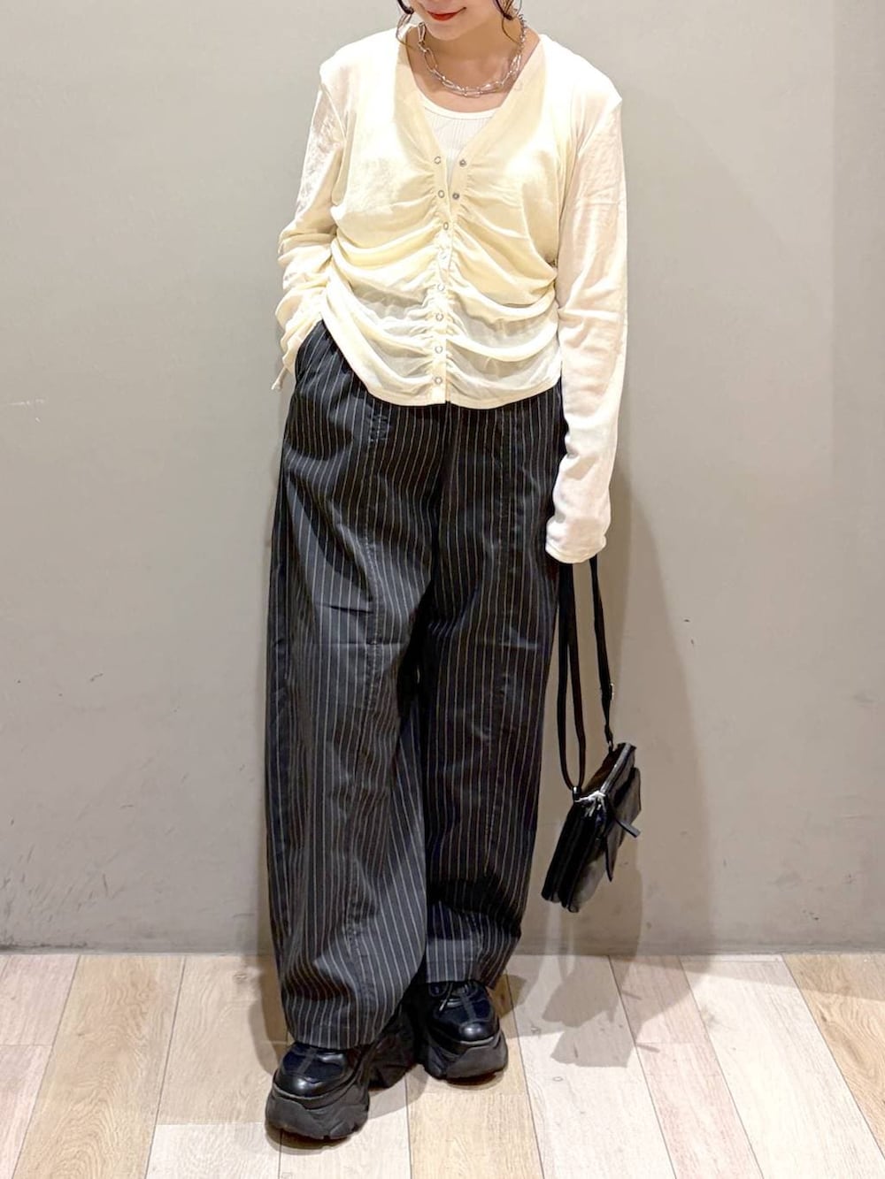 ブラック系のスニーカー、ブラック系のその他パンツ、ホワイト系のタンクトップを着用したレディースの夏コーディネートの3枚目の写真