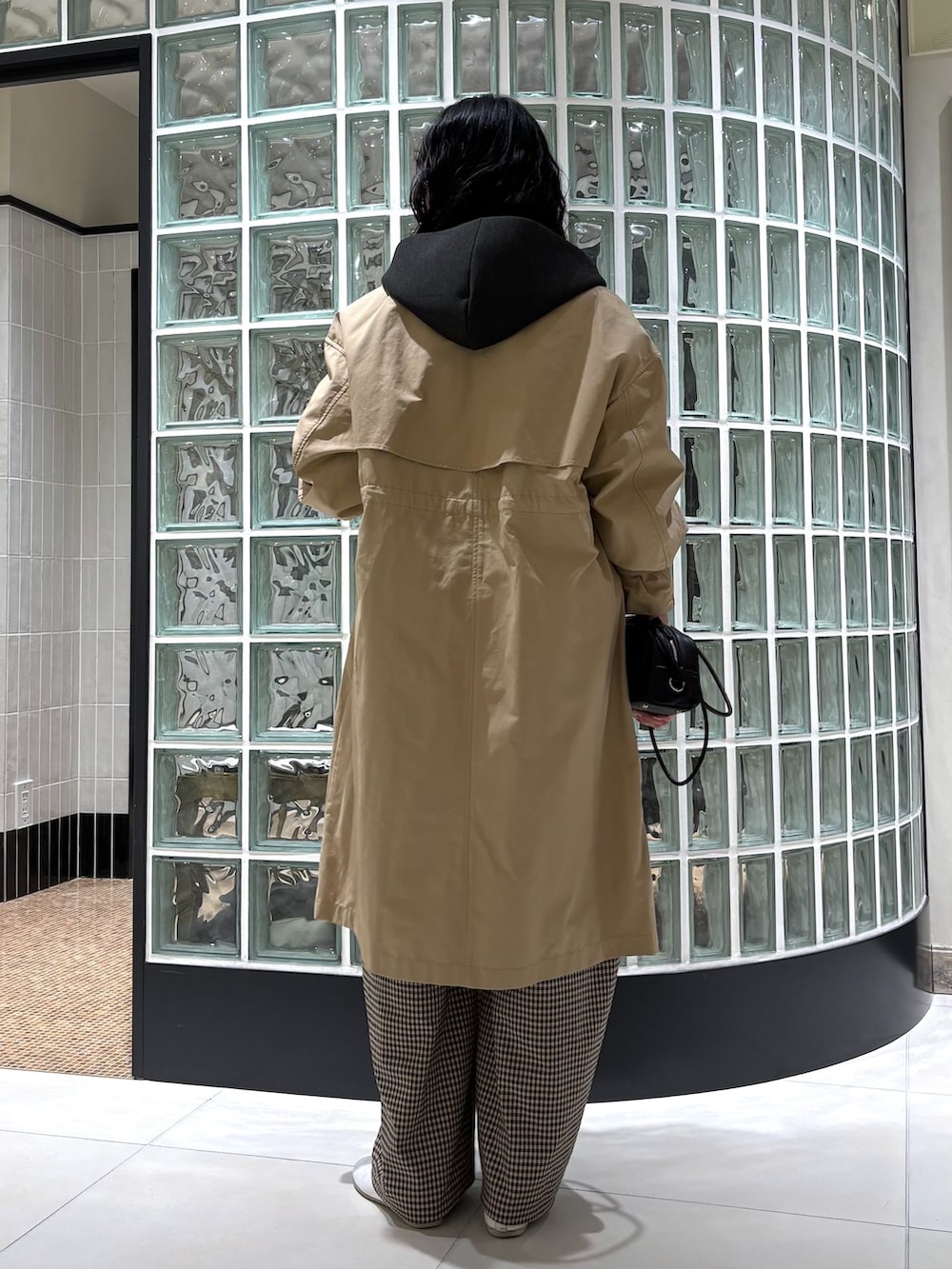 ベージュ系のステンカラーコート、ベージュ系のその他パンツ、ホワイト系のシャツ/ブラウスを着用したレディースの冬コーディネートの4枚目の写真