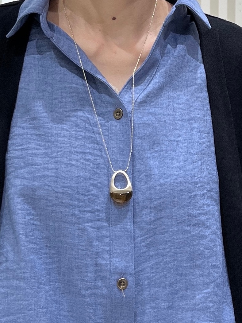 ブルー系のシャツ/ブラウス、グレー系のその他パンツ、ブラック系のパンプスを着用したレディースの秋コーディネートの6枚目の写真