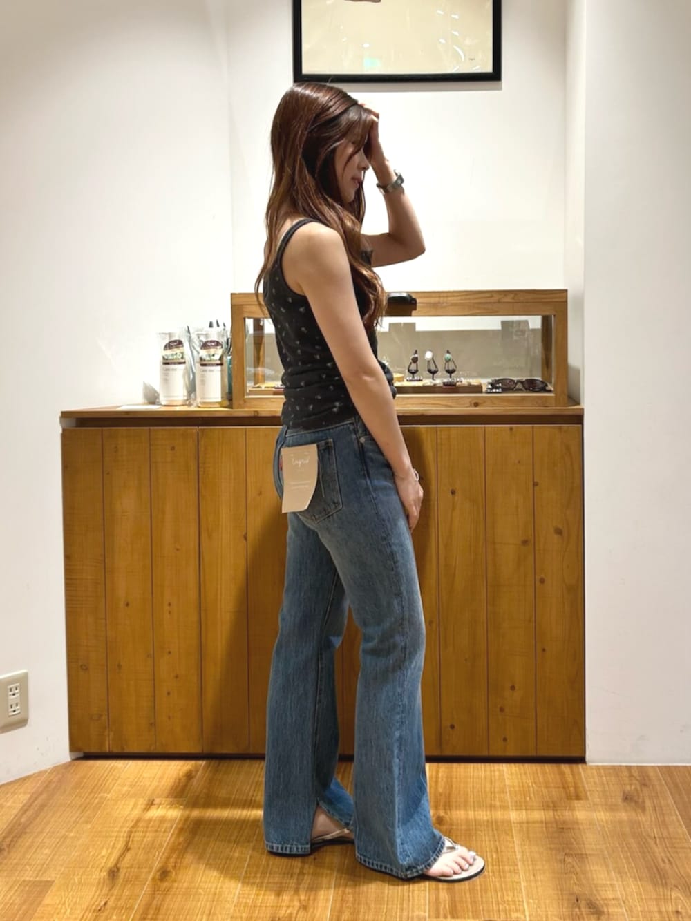 ブルー系のデニムパンツ、グレー系のキャミソール、ブラウン系のその他シューズを着用したレディースの夏コーディネートの3枚目の写真