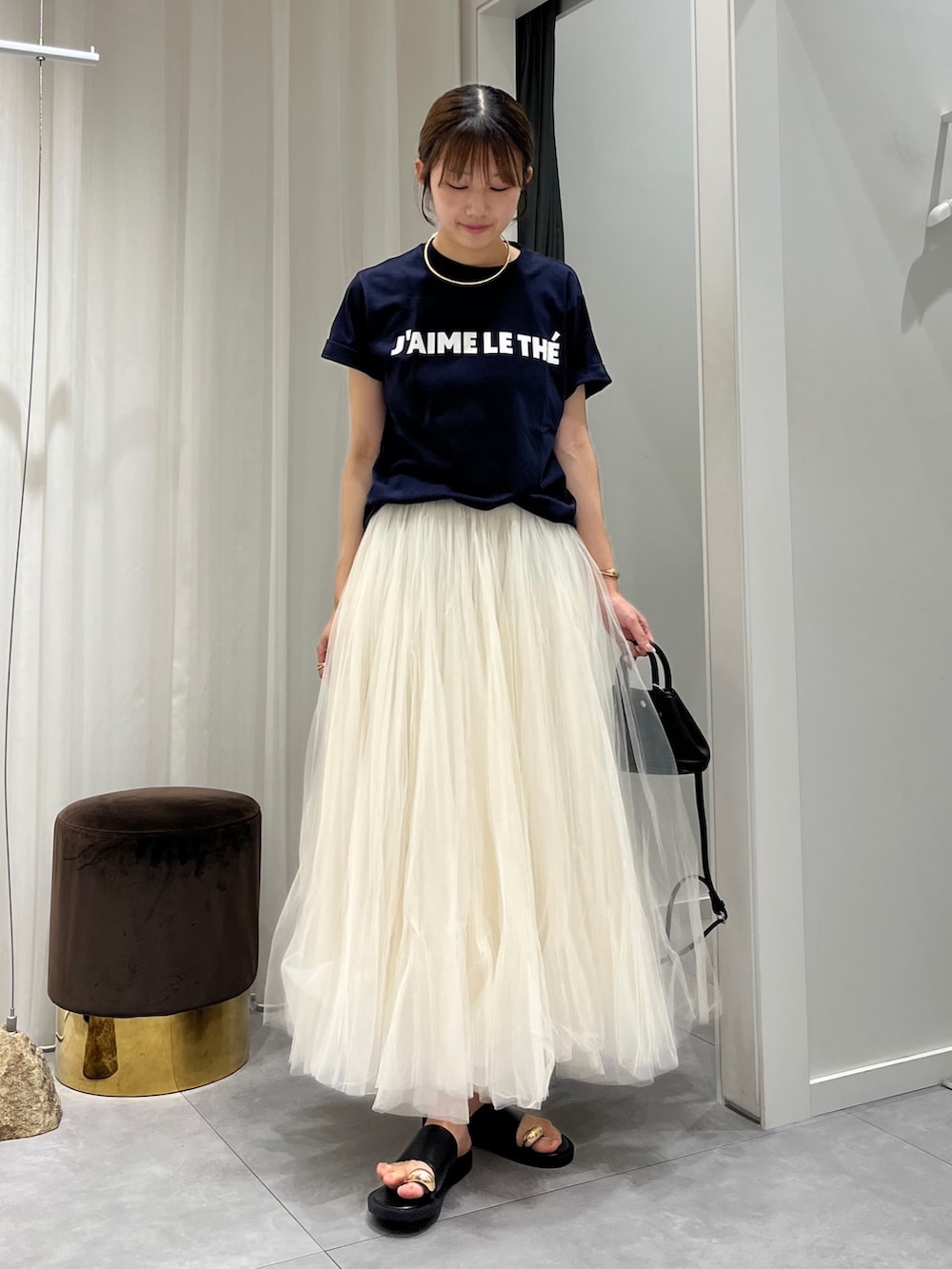 ブルー系のTシャツ/カットソー、ホワイト系のスカート、ブラック系のショルダーバッグを着用したレディースの夏コーディネートの4枚目の写真