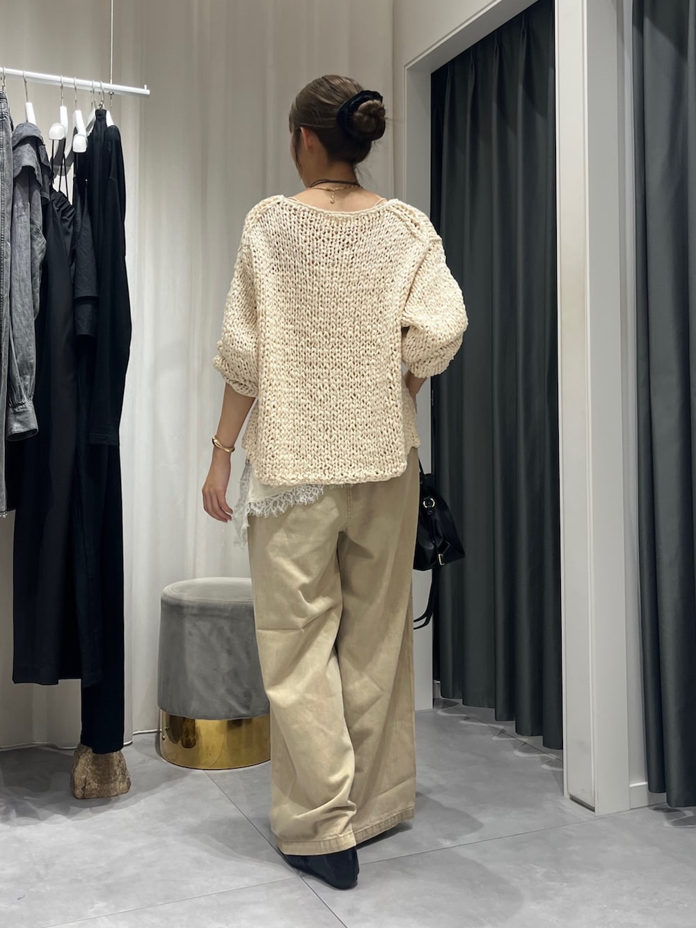 ホワイト系のニット/セーター、ホワイト系のシャツ/ブラウス、ベージュ系のデニムパンツを着用したレディースの秋コーディネートの4枚目の写真