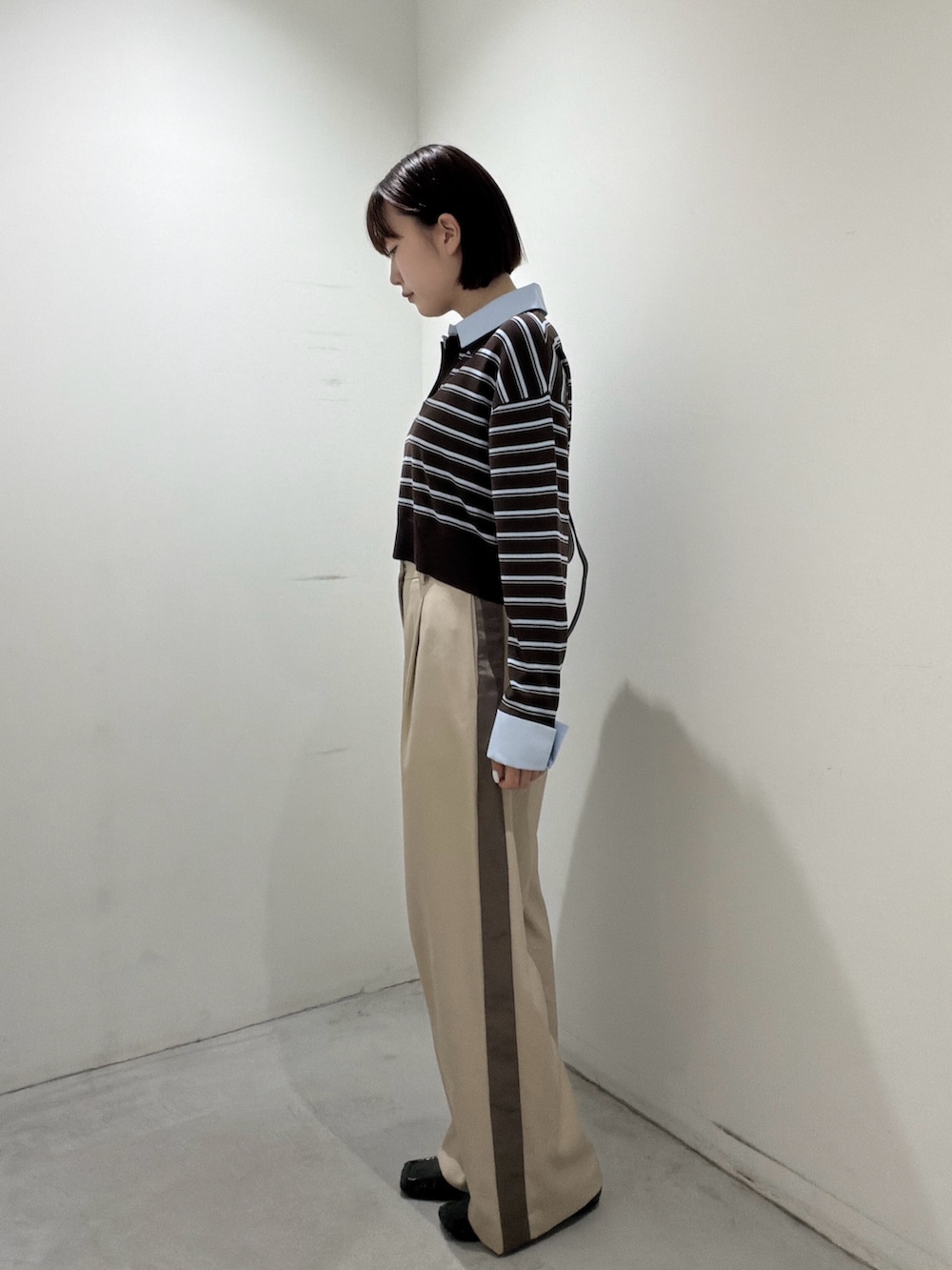 ブラウン系のニット/セーター、ブラック系のショルダーバッグ、ベージュ系のその他パンツを着用したレディースの夏コーディネートの4枚目の写真